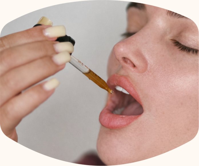 Dropper placing tincture under the tongue
