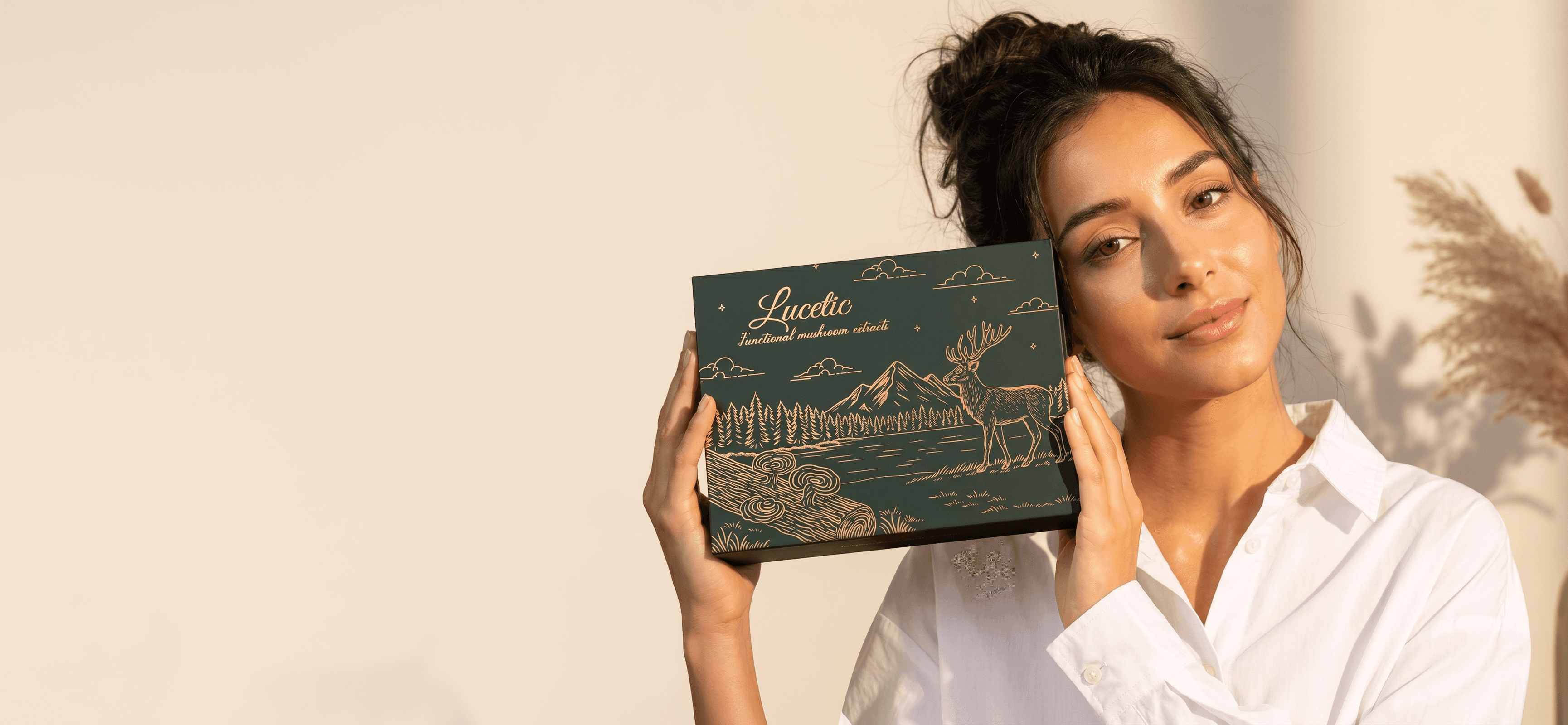 Woman holding the Lucetic Wellness Combo Box